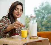 Woman is drinking milk added on top with iyaraa saffron